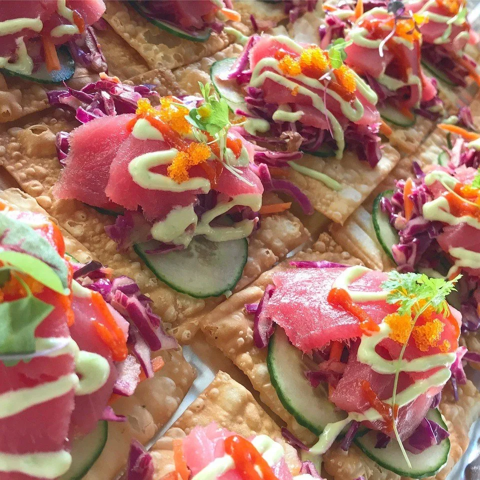 Seared ahi tuna on crispy wonton crisps from a catering spread